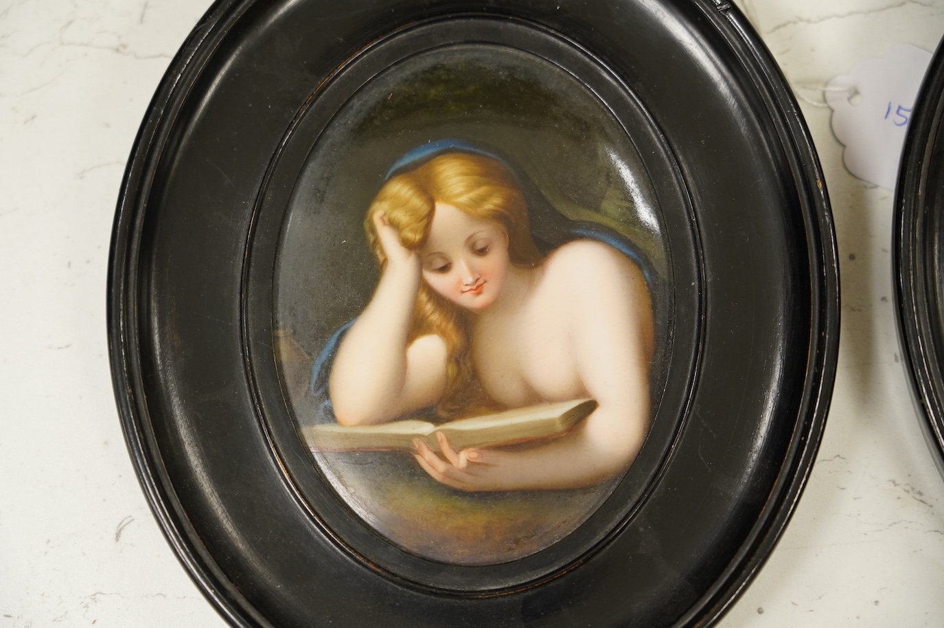 A pair of mid 19th century Paris porcelain plaques decorated with portraits of female figures, both in oval ebonised frames. Condition - fair to good